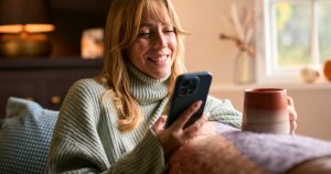 woman smiling at phone