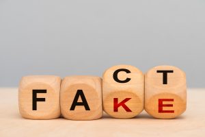 fact or fake printed on wooden blocks